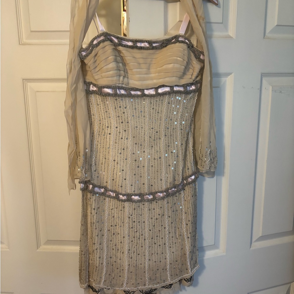 Beaded and sequined nude dress with pink ribbon accents by Gracia